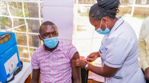 Profissional de saúde com equipamentos de proteção individual em laboratório de pesquisa, representando o desenvolvimento de novos tratamentos e vacinas experimentais contra o vírus Ebola recomendados pela OMS.