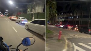 Fila de veículos aguardando entrada em motel na Avenida Ayrton Senna da Silva, em Praia Grande, durante a noite.