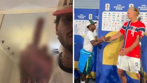 Zé Felipe reage em vídeo, demonstrando indignação ao ver Vini Jr. abraçar Erling Haaland após a eliminação do Brasil, em imagem de bastidores com roupas e bandeira do evento.