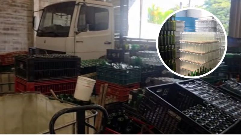 Empresa irregular em Campinas com caminhão estacionado e grande quantidade de garrafas e frascos contendo produtos químicos em área interna, incluindo destaque para recipientes