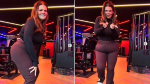 Thais Carla dança em um set de academia com luzes neon coloridas, posando confiante no palco enquanto comemora após a separação, com expressão de alegria e liberdade
