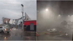 Caminhão de ajuda humanitária do Governo de SP chegando em Ribeirão Preto após vendavais, com equipe e carga em um cenário de chuva e detritos na estrada.