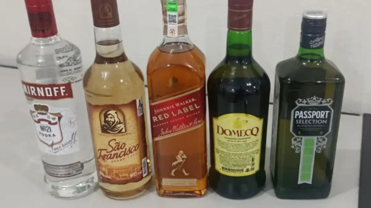 Homem é preso após furto de bebidas de supermercado em Bragança Paulista, com garrafas de álcool apreendidas em primeiro plano em registro policial.