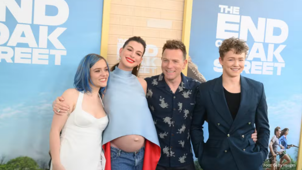 Gravidez de Anne Hathaway em première de novo filme, com a atriz grávida em destaque ao lado de atores e equipe em foto de chegada ao evento, em ambiente de tapete azul.