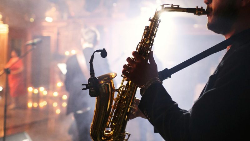 Mostra Jazz Campinas com músicos em palco tocando saxofone e outros instrumentos em um show de jazz, com luzes e clima de apresentação durante o evento de agosto em Campinas.