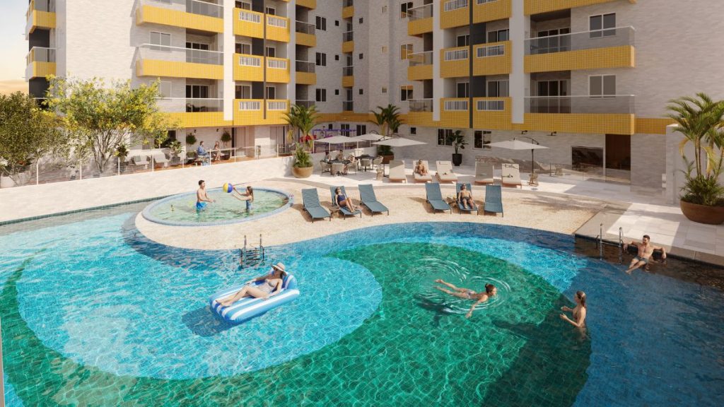 Piscina em formato circular e área de lazer de empreendimento residencial com fachada de blocos amarelos e varandas, em Campo Grande, no Gran Canal Residence em Santos.