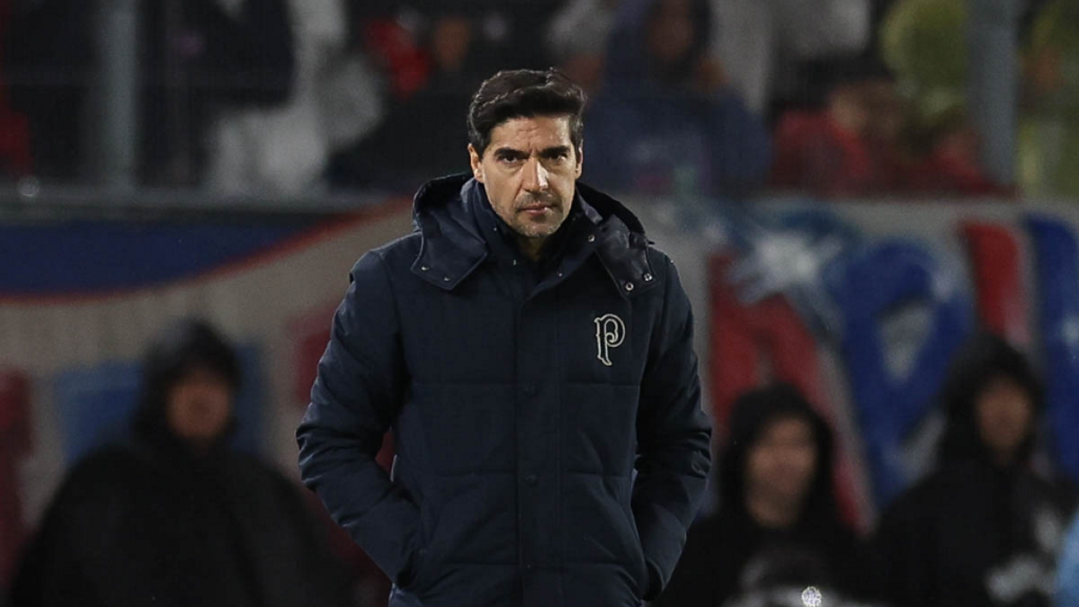 Abel Ferreira em campo, com expressão séria, após classificação do Palmeiras; o treinador gesticula e parece desabafar, em imagem de partida com arquibancada ao fundo.