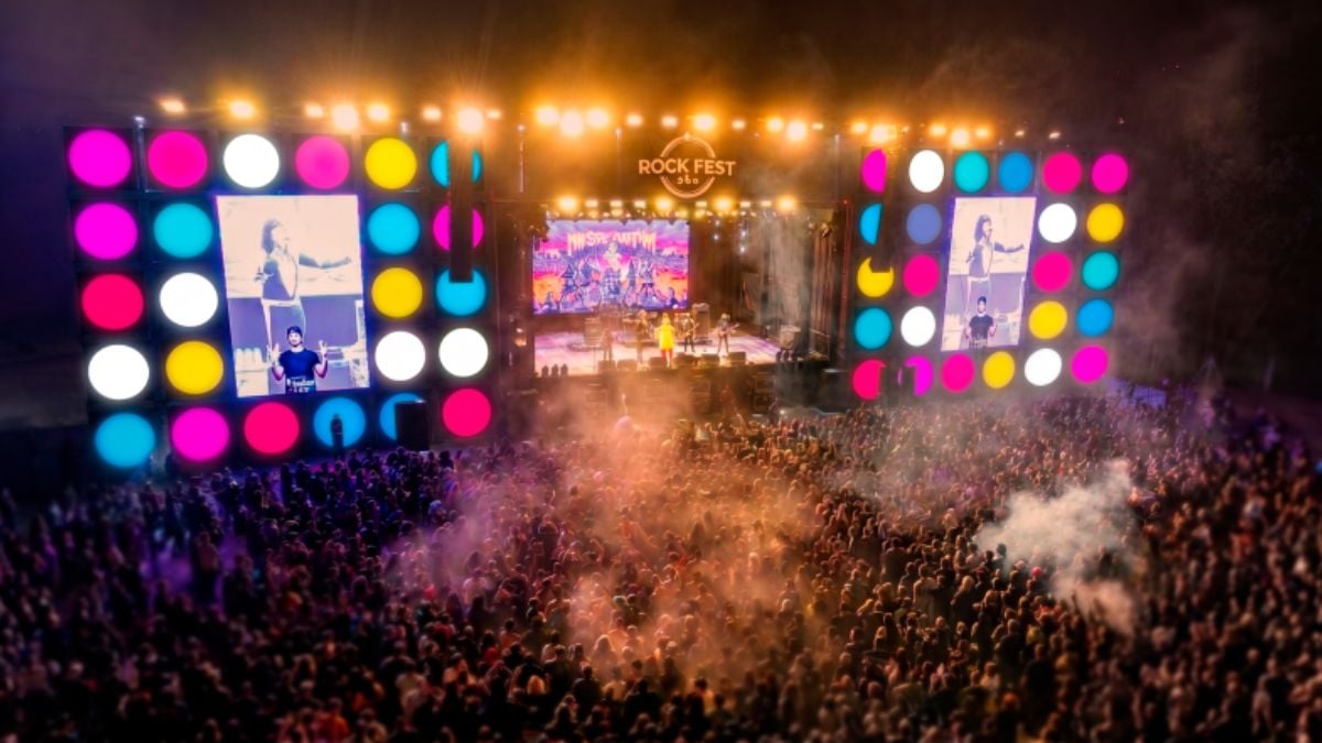 Santa Bárbara Rock Fest 2026: palco de rock com show ao vivo e multidão lotando o evento, luzes coloridas e fumaça no ar durante os shows gratuitos