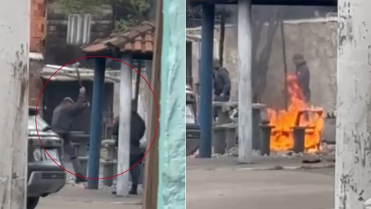 Praça destruída em Santos com bancos e mesas danificados após ação policial, visíveis escombros e pessoas ao fundo em área cercada, conforme registro em vídeo.