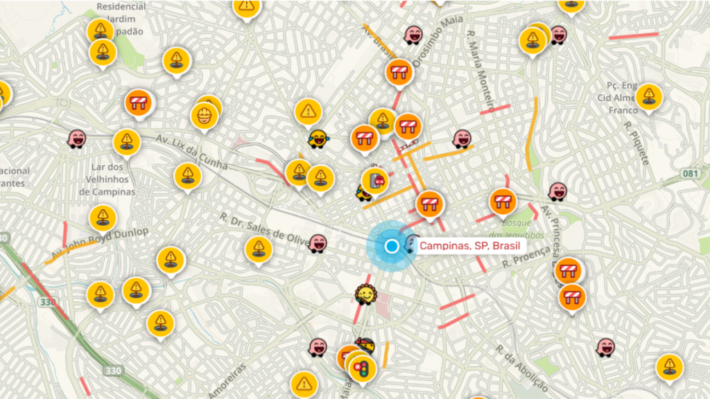 Mapa de localização de Campinas, SP, Brasil com marcador central e vários ícones de alerta e informações de trânsito, incluindo sinais de perigo e emojis ao redor.