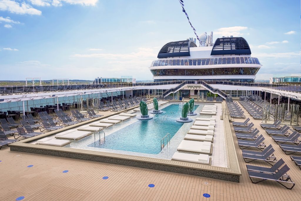 temporada de cruzeiros 2026/2027: Piscina Atmosphere Pool do cruzeiro MSC Virtuosa, com espreguiçadeiras ao redor e vista do navio ao fundo, em céu claro