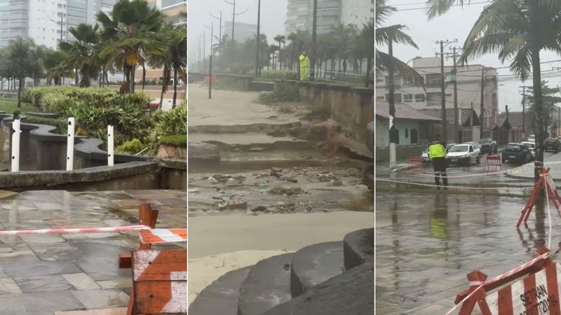 Cratera em Praia Grande vista no calçadão com água e buracos na pista, isolada com barreiras e cones, em meio a moradores e chuva; ao fundo, prédios e palmeiras.