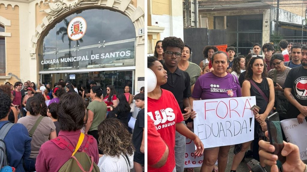 Manifestantes com cartazes em frente à Câmara Municipal de Santos, incluindo uma faixa com a palavra “FORA EDUARDA!”, em protesto na cidade.